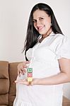 Beautiful Hispanic Pregnant Woman Having The Word Boy With Woode Stock Photo