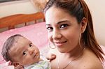 Beautiful Hispanic Young Mother Is Holding Her Newborn Baby Stock Photo
