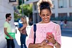 Beautiful Student Girl Using Her Mobile Phone In The Street Stock Photo
