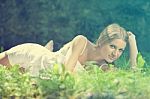 Beautiful Woman Lying On The Grass, Rest In Nature Stock Photo
