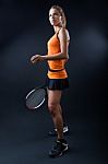 Beautiful Woman Playing Tennis Indoor. Isolated On Black Stock Photo