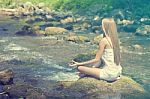 Beautiful Woman Practive Yoga On River In Nature Stock Photo