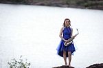 Beautiful Woman Wear Blue Evening Dress Holding Saxophone Stand Stock Photo