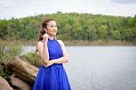 Beautiful Woman Wear Blue Evening Dress Over Mountains And River Stock Photo
