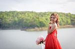 Beautiful Woman Wear Red Evening Dress Hold A Bouquet Of Flowers Stock Photo