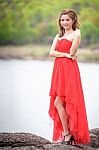 Beautiful Woman Wear Red Evening Dress Over Mountains And Rivers Stock Photo