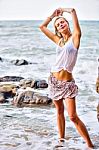 Beautiful Young Blonde Woman Posing Outdoor At The Rocky Sea Sho Stock Photo