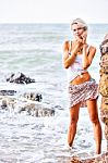 Beautiful Young Blonde Woman Posing Outdoor At The Rocky Sea Sho Stock Photo