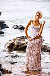 Beautiful Young Blonde Woman Posing Outdoor At The Rocky Sea Sho Stock Photo