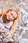Beautiful Young Blonde Woman Posing Outdoor At The Rocky Sea Shore Stock Photo