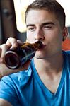 Beautiful Young Man Drinking Beer In The Bar Stock Photo