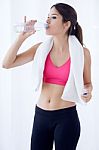 Beautiful Young Woman Drinking Water After A Workout At Home Stock Photo