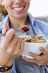 Beautiful Young Woman Eating Cereals At Home Stock Photo