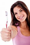 Beautiful Young Woman Holding Toothbrush And Smiling Stock Photo