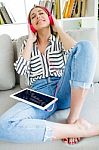 Beautiful Young Woman Listening To Music With Digital Tablet Stock Photo