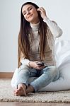 Beautiful Young Woman Listening To Music With Mobile Phone At Ho Stock Photo