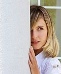 Beautiful Young Woman Near White Column Stock Photo