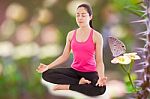 Beautiful Young Woman Practicing Yoga (lotus Position), Butterfl Stock Photo
