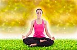 Beautiful Young Woman Practicing Yoga, Sitting In A Lotus Positi Stock Photo