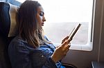 Beautiful Young Woman Reading A Book In The Train Stock Photo