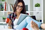 Beautiful Young Woman Using Her Digital Tablet At Home Stock Photo