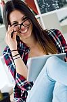 Beautiful Young Woman Using Her Digital Tablet At Home Stock Photo