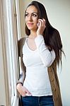Beautiful Young Woman Using Her Mobile Phone At Home Stock Photo