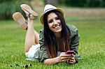Beautiful Young Woman Using Her Mobile Phone In The Park Stock Photo