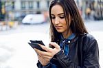 Beautiful Young Woman Using Her Mobile Phone In The Street Stock Photo