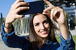 Beautiful Young Woman Using Her Mobile Phone In The Street Stock Photo