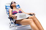 Beautiful Young Woman With Bikini Sitting On A Beach Chair Stock Photo