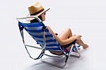 Beautiful Young Woman With Bikini Sitting On A Beach Chair Stock Photo
