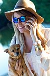 Beautiful Young Woman With Her Dog Using Mobile Phone Stock Photo