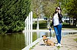 Beautiful Young Woman With Her Dog Using Mobile Phone Stock Photo