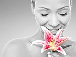 Beauty Woman With A Lily Flower Stock Photo