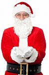 Bespectacled Father Santa Posing With Open Palms Stock Photo