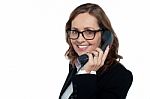 Bespectacled Woman Talking Over The Phone Stock Photo