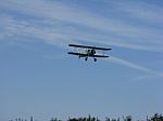 Biplane In Flight With Clouds Stock Photo