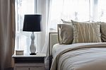 Black And White Lamp On Wooden Table In Luxury Bedroom Stock Photo