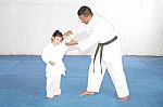 Black Belt Karate Teaching A Little Girl Stock Photo