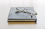 Black Book With Glasses Stock Photo