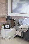 Black Lamp On White Table In Bedroom Stock Photo