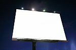 Blank Illuminated Billboard Over Evening Sky Stock Photo