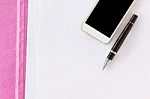 Blank Paper Note With Pen On Business File Folder And Cellphone Stock Photo