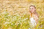 Blond Girl On The Camomile Field Stock Photo