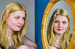 Blonde Girl Looking In Mirror Stock Photo
