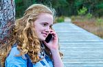 Blonde Girl Phoning Mobile In Nature Stock Photo