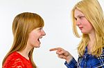 Blonde Girl Pointing At Redhead Girlfriend Stock Photo