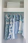 Blue Color Tone Girl's Dress Hanging In Wardrobe Stock Photo