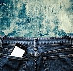 Blue Jeans With Cell Phone, Flashlight And Passport In A Pocket Stock Photo